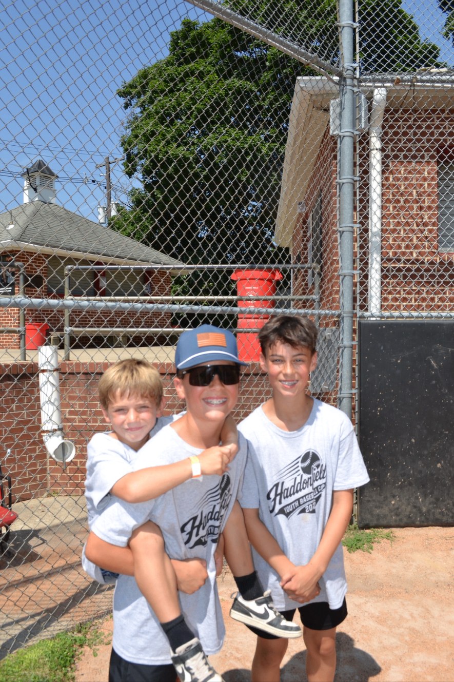 Three campers laughing together at Haddonfield Youth Baseball Camp
